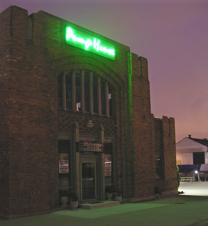The PumpHouse sign lit at night.